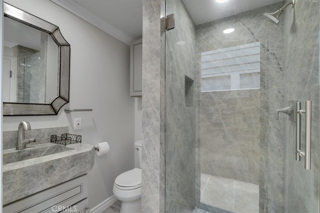 2808 West Oceanfront Newport Beach, CA 92663 - Photo 25 of 31 a bathroom with a sink a toilet and shower