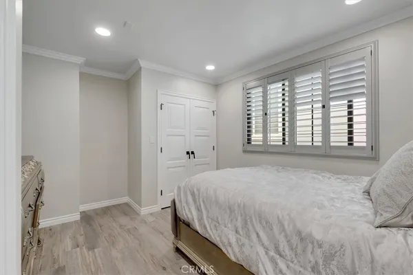 a spacious bedroom with a bed and a window