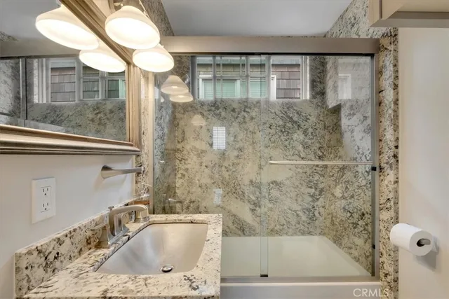a bathroom with a shower and a sink