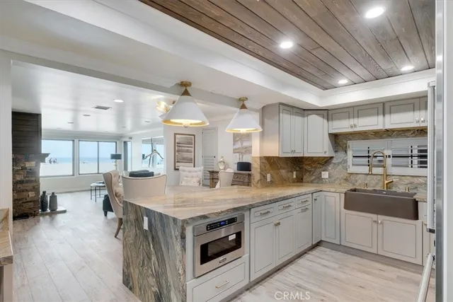 a kitchen with a sink stainless steel appliances and cabinets