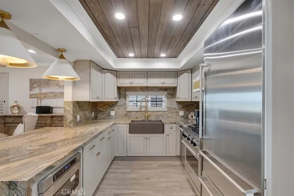 a kitchen with a sink stainless steel appliances and cabinets