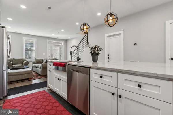 a living room with granite countertop furniture and a chandelier