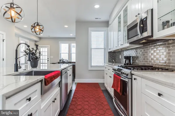 a kitchen with stainless steel appliances granite countertop a stove and a sink
