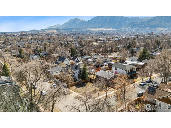 an aerial view of residential houses with city view