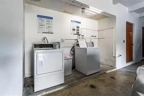 a view of a storage & utility room with refrigerator and wooden floor