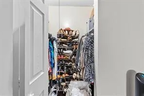 a view of walk in closet with clothes