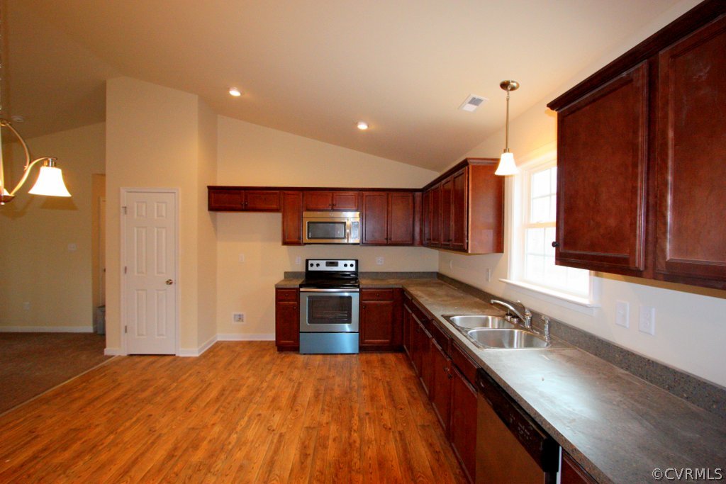 16 Winding Ridge Way Bumpass, VA 23024 - Photo 11 of 20 a kitchen with stainless steel appliances granite countertop a stove a sink dishwasher and a refrigerator with wooden floor