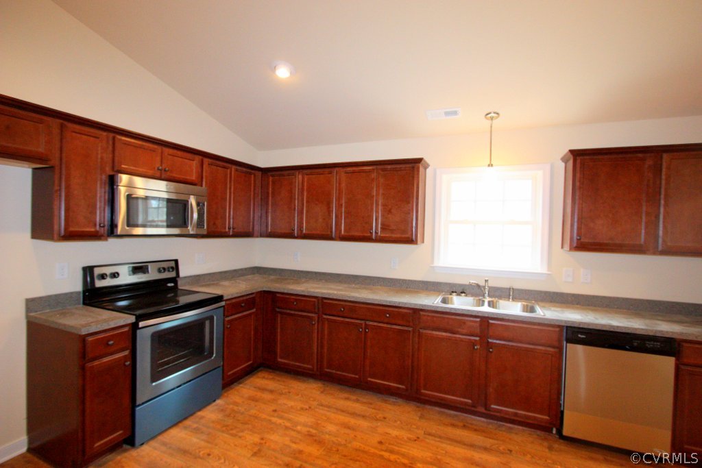 16 Winding Ridge Way Bumpass, VA 23024 - Photo 12 of 20 a kitchen with granite countertop stainless steel appliances a sink a stove cabinets and wooden floor