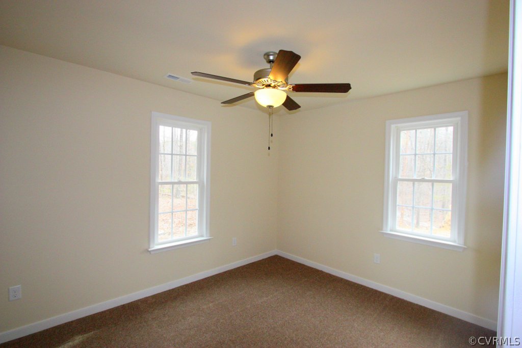 16 Winding Ridge Way Bumpass, VA 23024 - Photo 16 of 20 an empty room with windows and fan