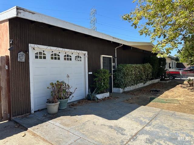 a backyard of a house with potted plants