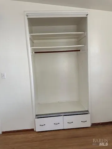 an empty room with wooden floor