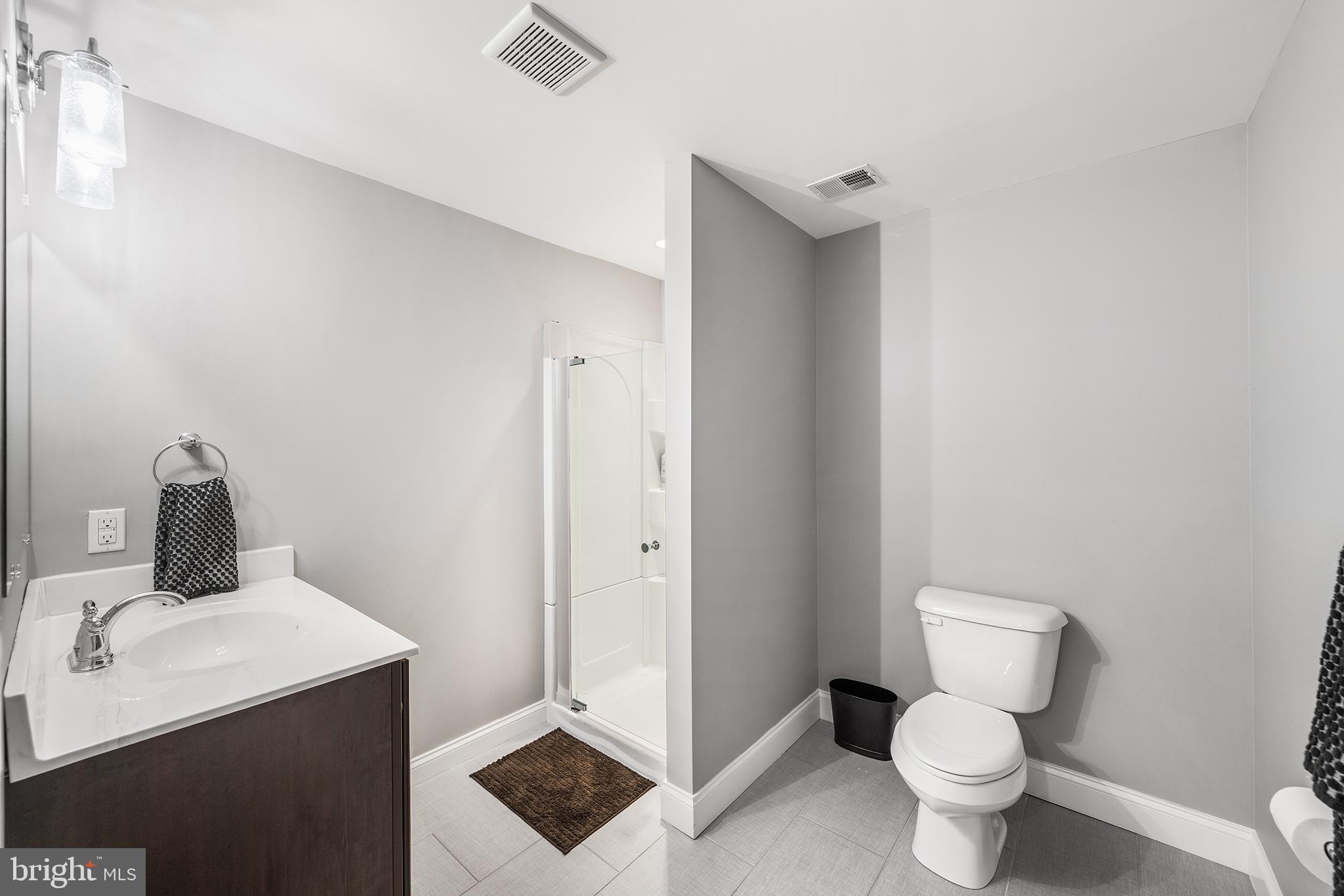 515 Old Eagle School Road Wayne, PA 19087 - Photo 35 of 40 a bathroom with a toilet sink and a mirror
