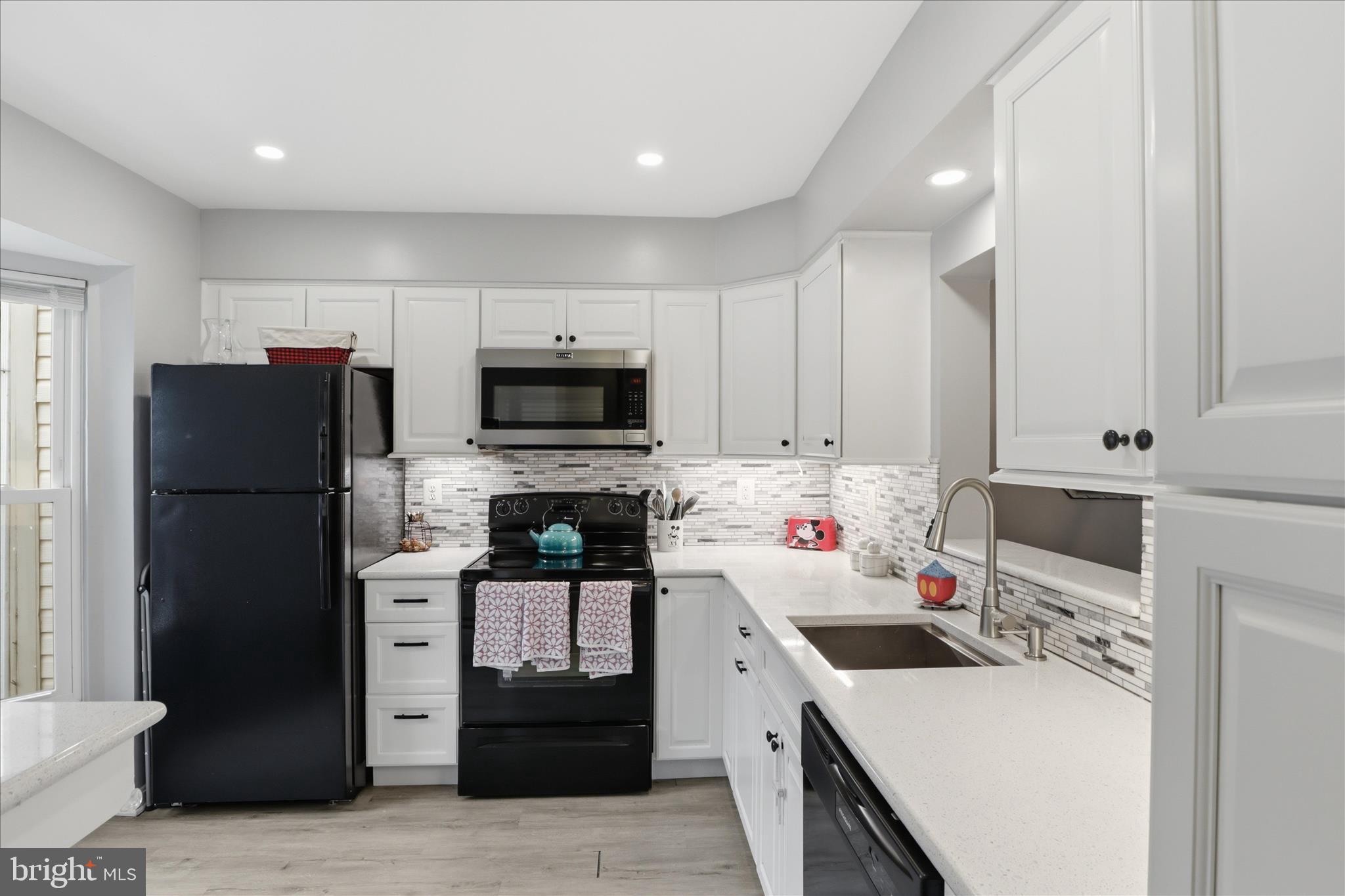 71 Kinsman View Circle Silver Spring, MD 20901 - Photo 9 of 42 a kitchen with a sink a stove and refrigerator