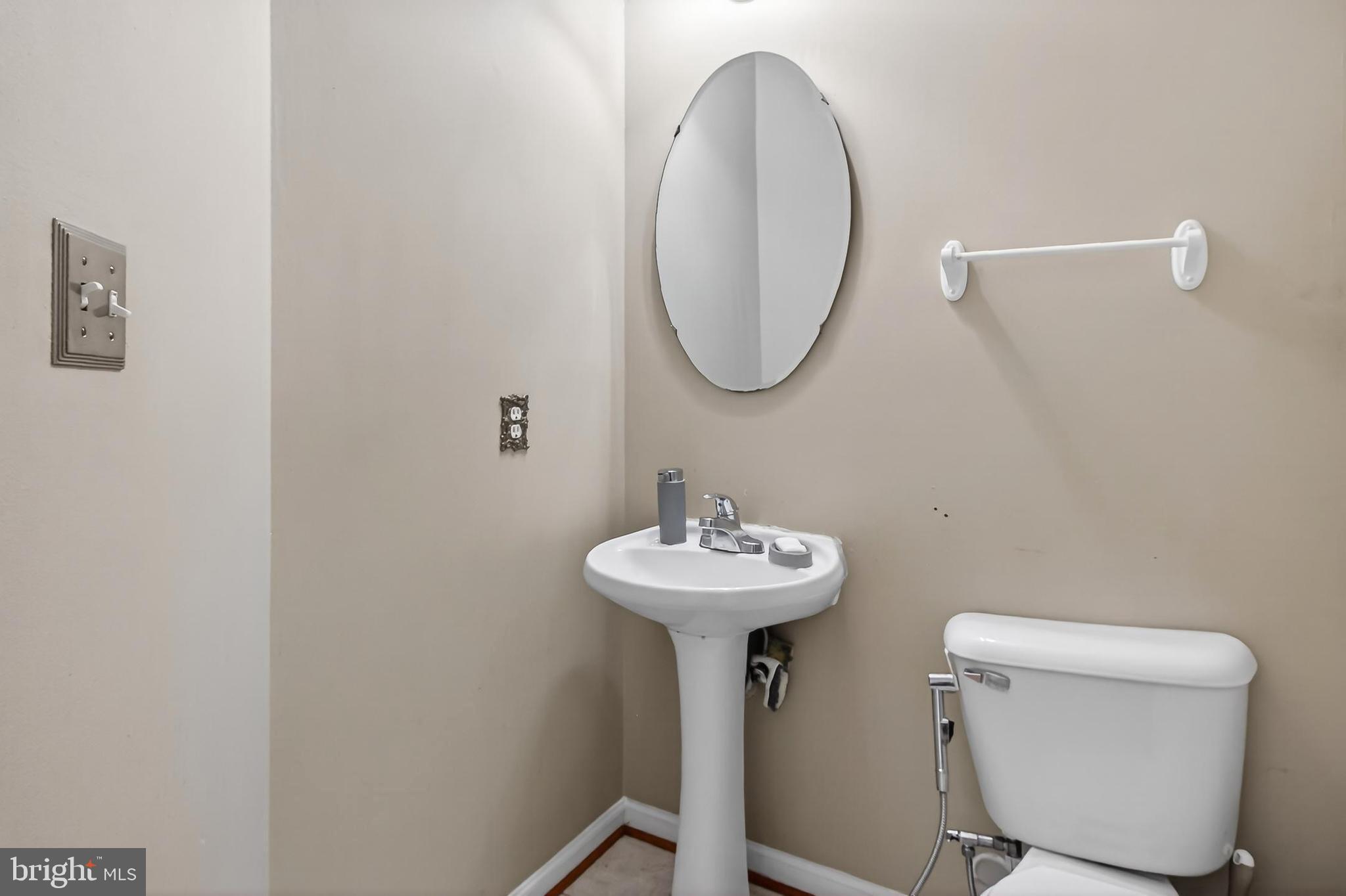 8602 Walcott Court Manassas, VA 20111 - Photo 19 of 53 a bathroom with a toilet a sink and a mirror