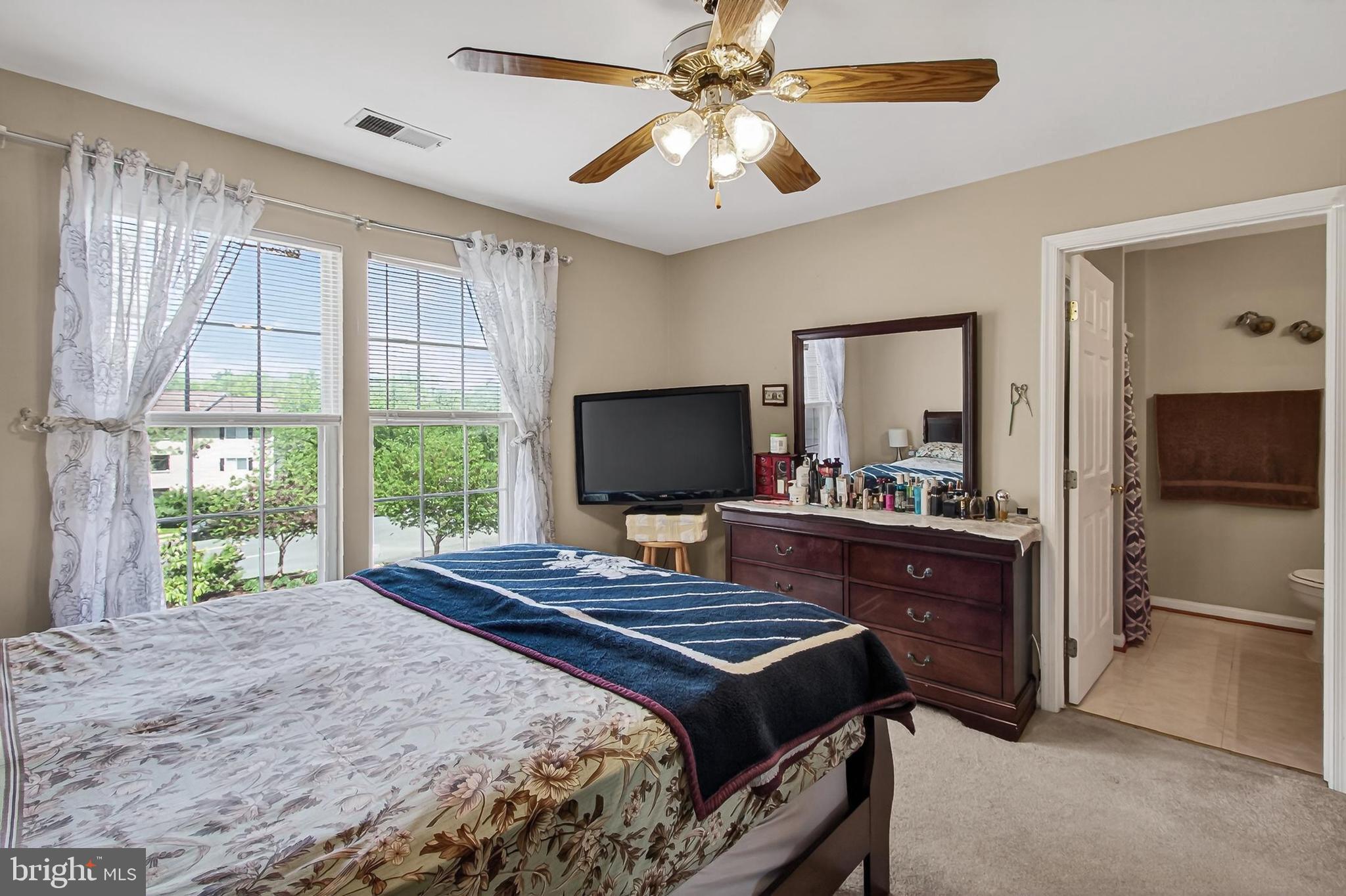 8602 Walcott Court Manassas, VA 20111 - Photo 22 of 53 a bedroom with a bed and a flat screen tv