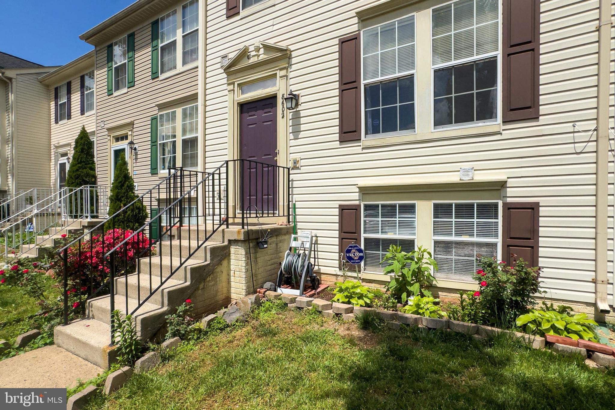 8602 Walcott Court Manassas, VA 20111 - Photo 4 of 53 a front view of a house with a yard
