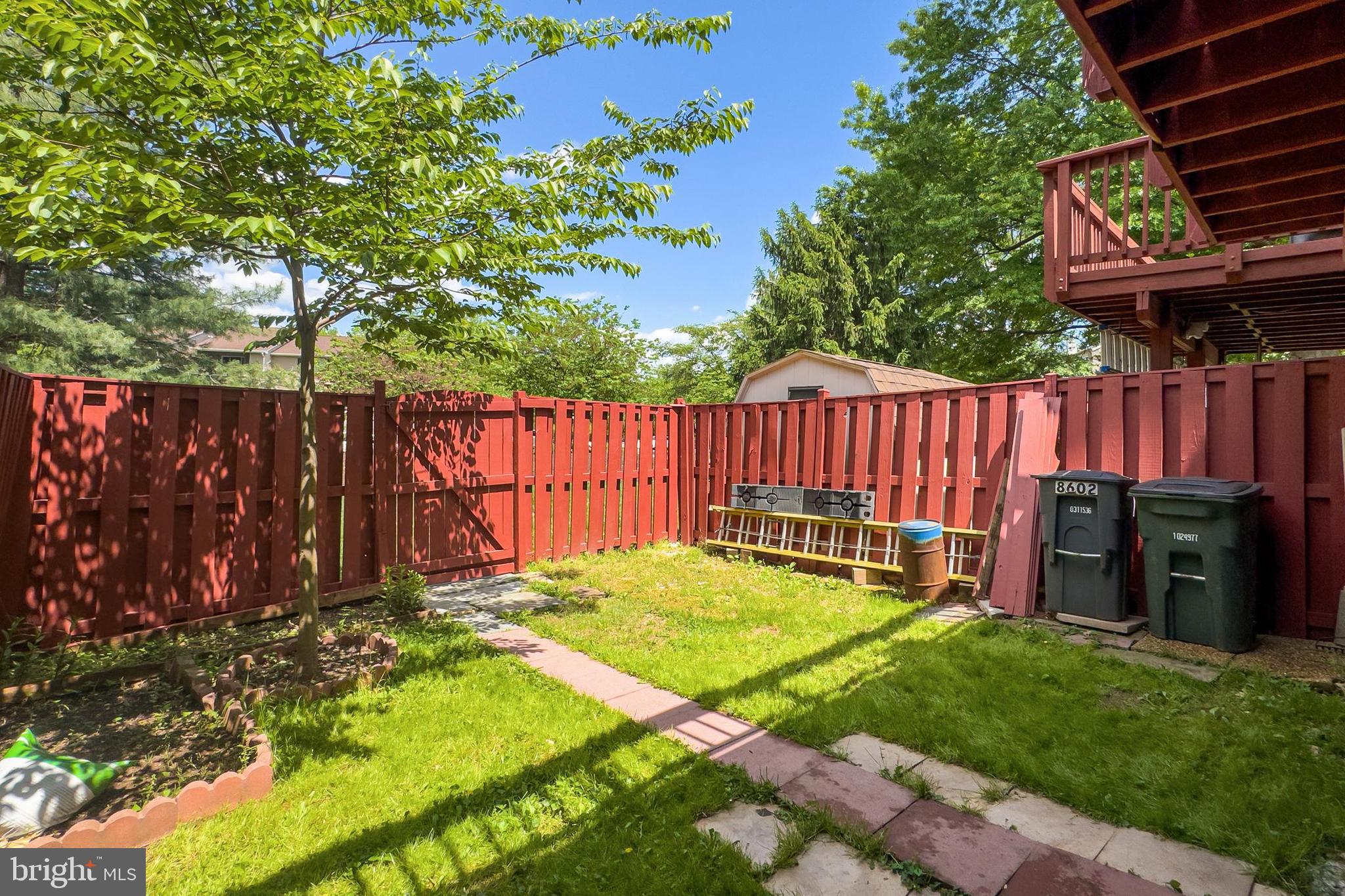 8602 Walcott Court Manassas, VA 20111 - Photo 45 of 53 a view of backyard with wooden fence and a large tree