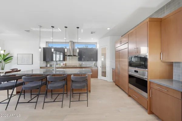 a large kitchen with a table and chairs