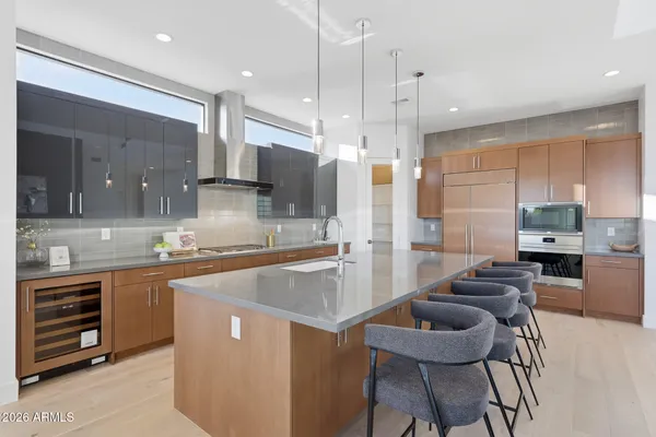 a large kitchen with stainless steel appliances kitchen island granite countertop a sink and cabinets