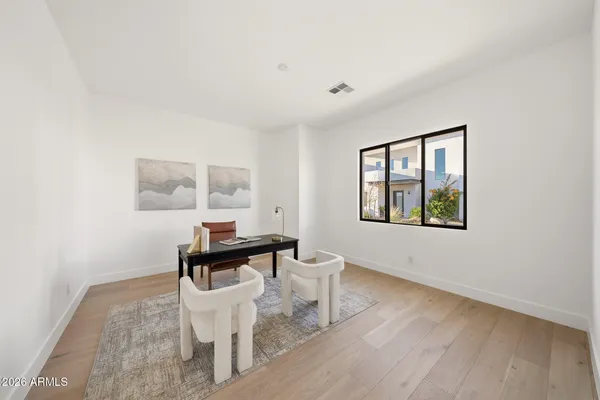 a view of a room with furniture and wooden floor