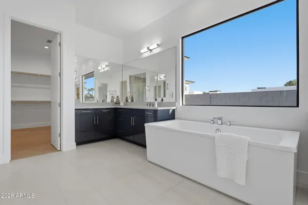 a large bathroom with a double vanity sink mirror and