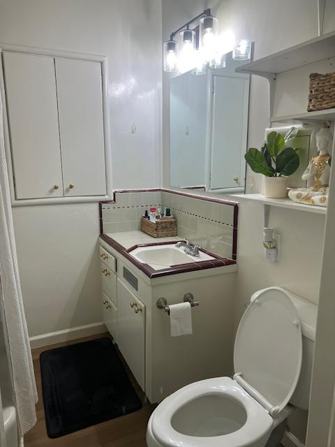165 East Linden Avenue Reedley, CA 93654 - Photo 16 of 19 a bathroom with a sink a toilet and mirror