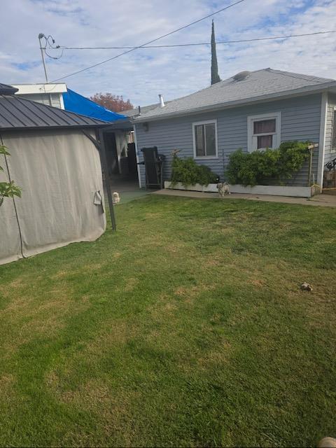 165 East Linden Avenue Reedley, CA 93654 - Photo 3 of 19 a view of a house with a backyard