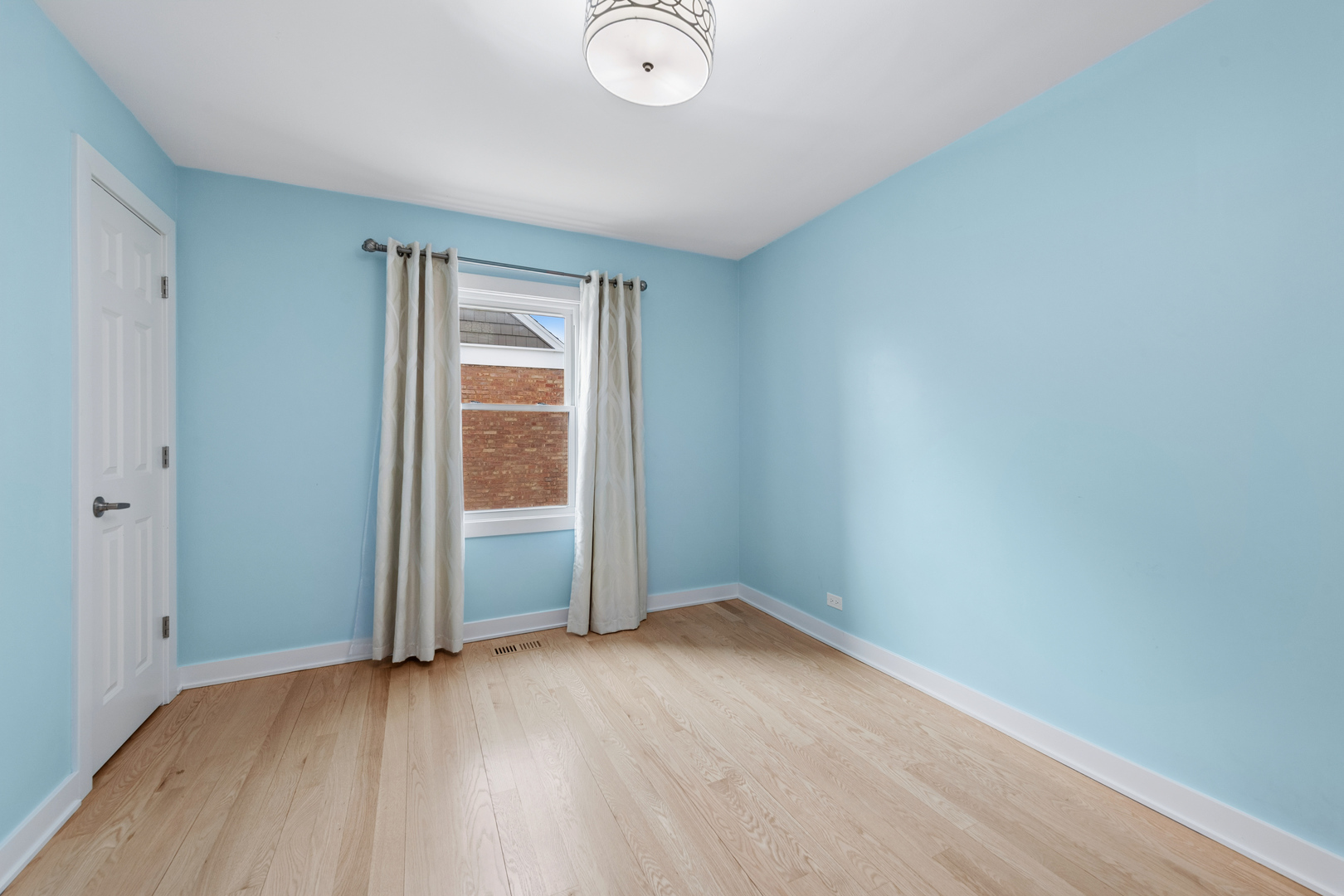 512 North Elm Street Mount Prospect, IL 60056 - Photo 9 of 24 an empty room with wooden floor and windows