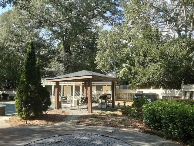 a view of a yard with large trees