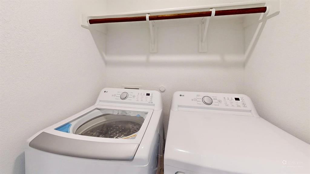 403 Ashbrook Way Princeton, TX 75407 - Photo 20 of 23 Dedicated laundry area featuring a white top-load washer and dryer set