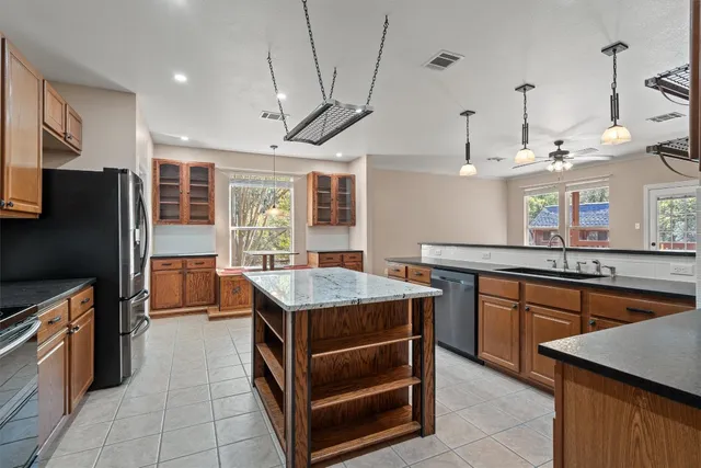a kitchen with stainless steel appliances granite countertop a stove and refrigerator