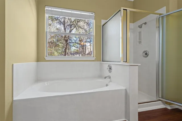 a white bath tub sitting next to a shower