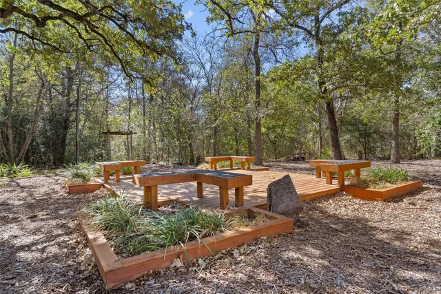 a backyard of a house with fountain table and chairs