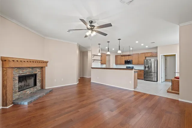 a view of a kitchen with wooden floor and a kitchen