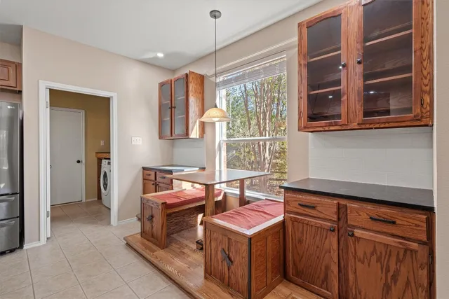 a kitchen that has a stove and a wooden cabinets