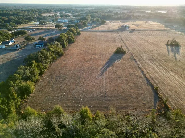 a view of a lake with beach and outdoor space