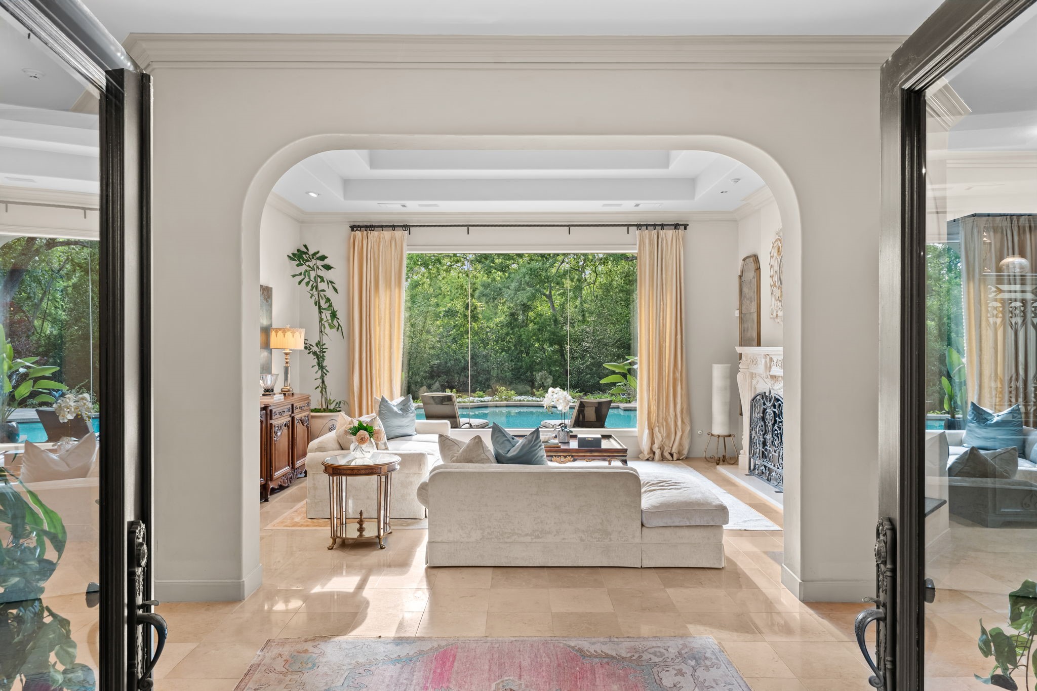 6 Mott Lane Houston, TX 77024 - Photo 11 of 50 Light-filled room with soaring ceilings and elegant architectural archways create a sophisticated first impression that sets the tone for the home's timeless design.
