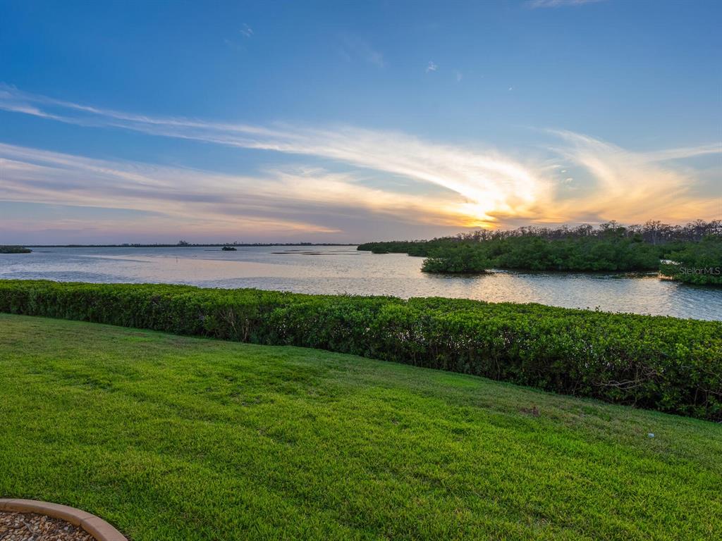 2424 Placida Road, Unit D102 Englewood, FL 34224 - Photo 1 of 1 a view of a lake with a big yard