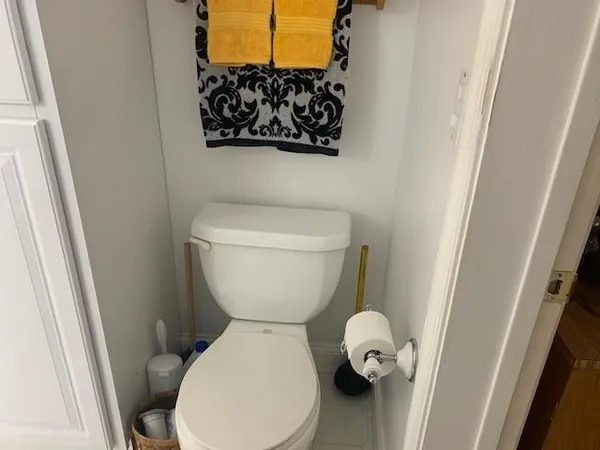 a white toilet sitting next to a sink