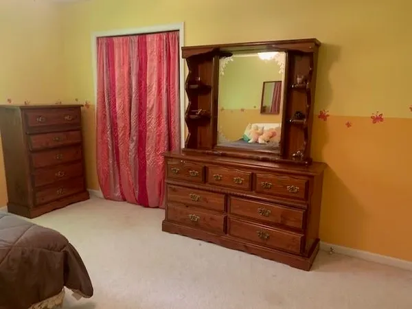 a living room with a bed and a mirror