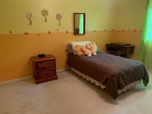 a bedroom with a bed and a lamp