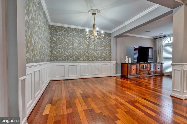 a view of a livingroom with wooden floor and furniture