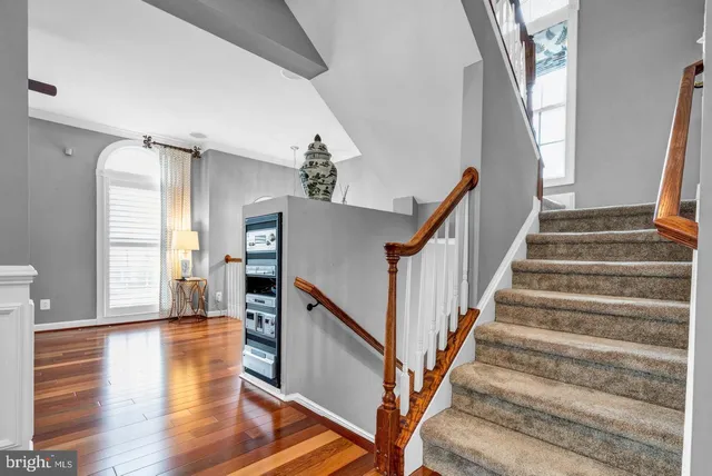 a view of an entryway with wooden floor and stairs