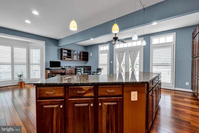 a kitchen with granite countertop a stove and a sink