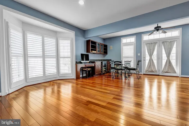 a living room with fireplace furniture and a wooden floor