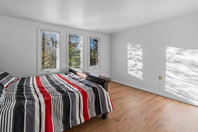a bed sitting in a bedroom next to a window