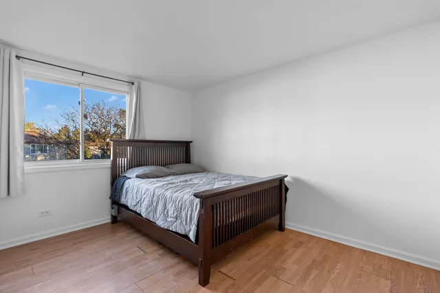 a bed sitting in a bedroom next to a window
