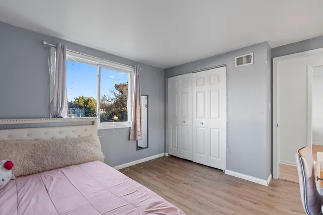 a bedroom with a large bed and a window