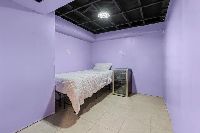 a bed room with a bed and a night stand