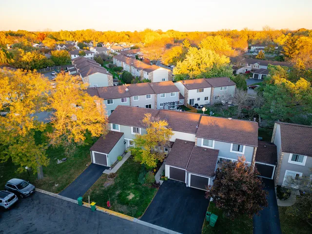 an aerial view of multiple houses with yard